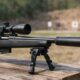 A modern hunting rifle equipped with a legally owned suppressor at an outdoor range — showing how suppressors are becoming part of responsible shooting culture.